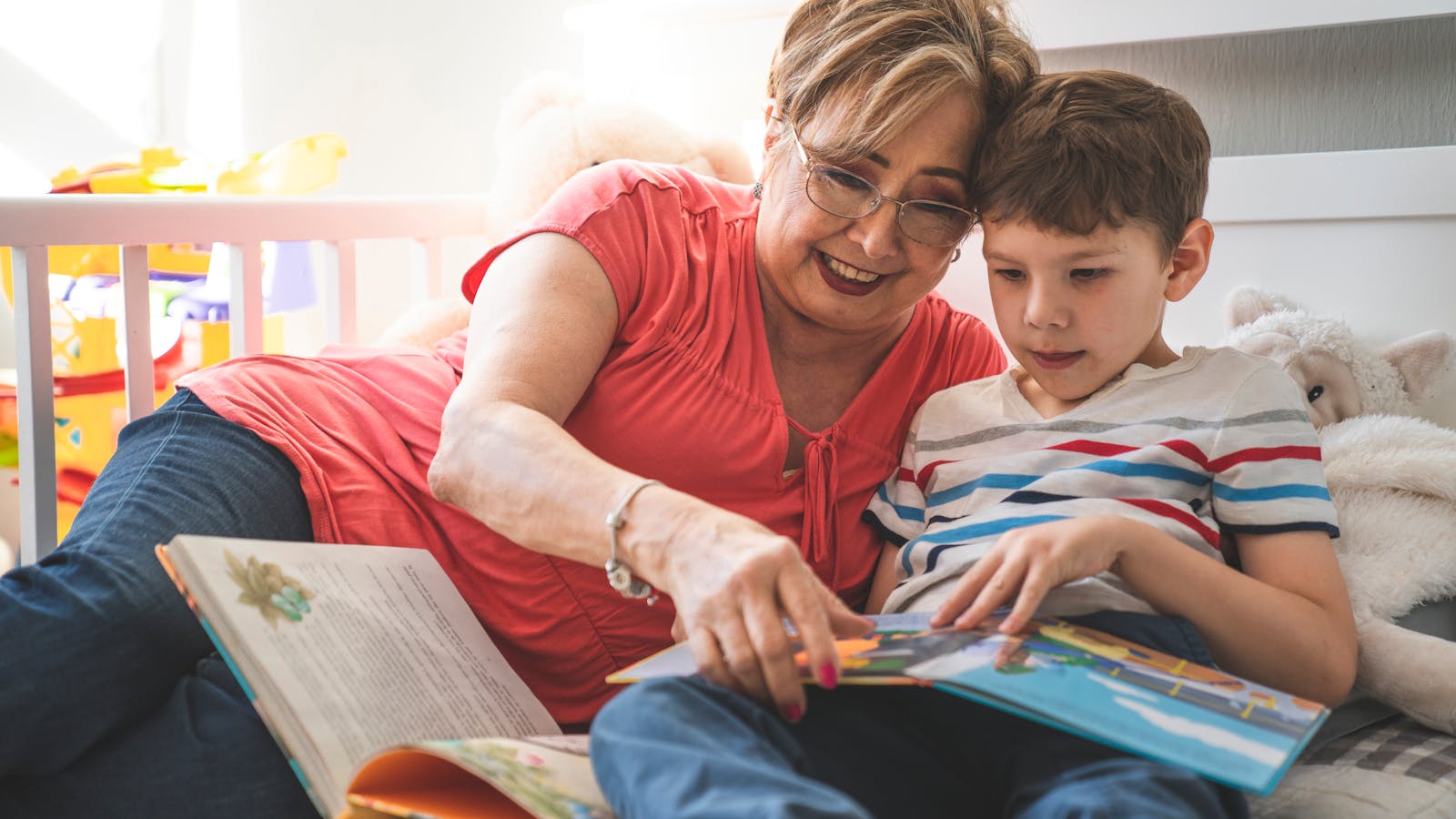 Grandmother and child reading the Bible together on a couch